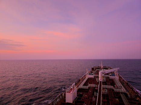 Stunning sunset view across the open sea from the deck of a cargo ship.